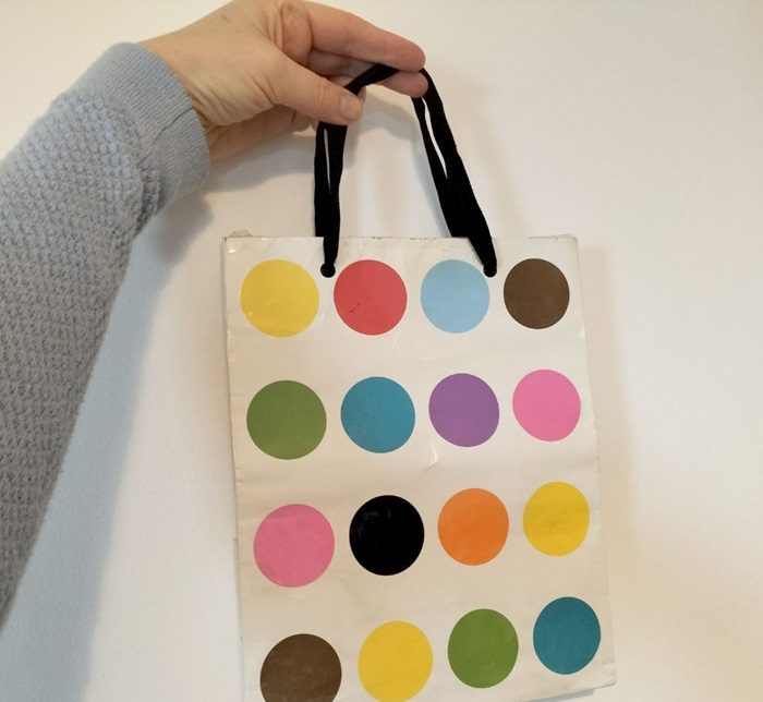 A cardboard shopping bag with lots of coloured circles on it. Kathryn M Crowley art and design Ireland.