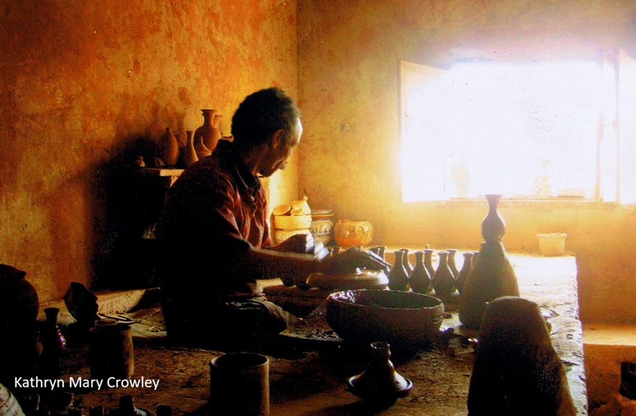 My photo of a potter. 
The man is working with clay. Sunlight pours through a window.